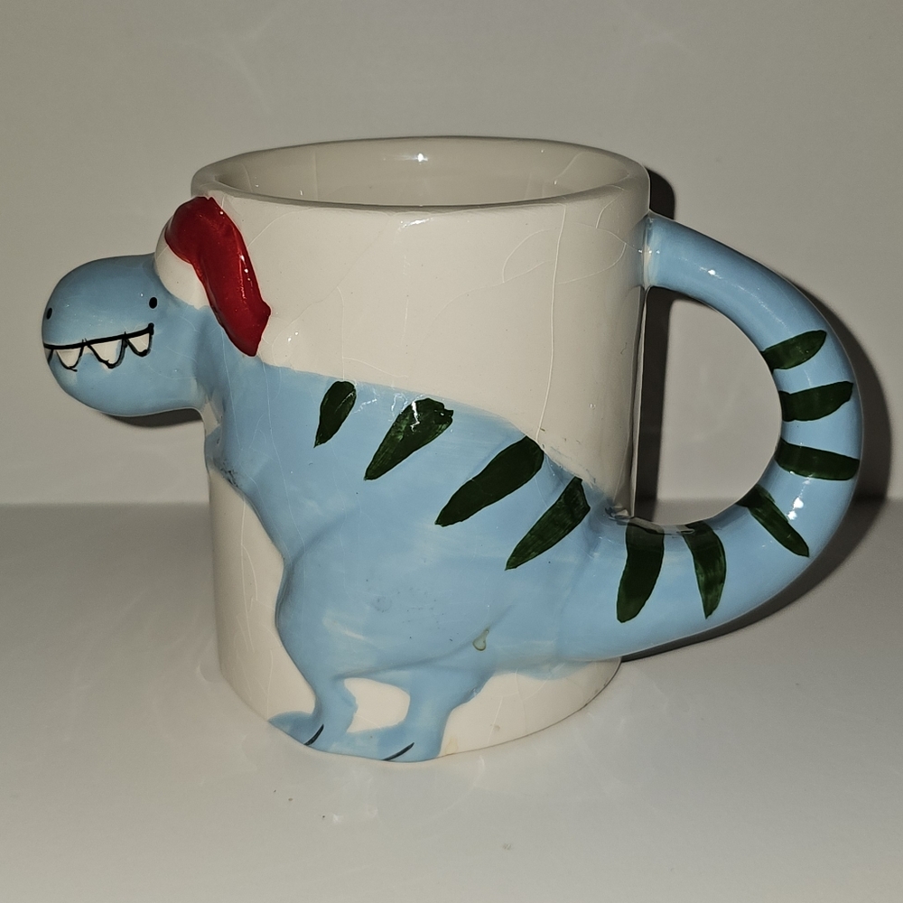 Whimsical Dinosaur Mug in Blue With Santa Hat.